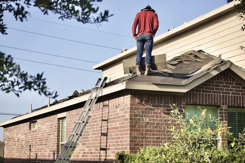 Professional roofer working on a residential roof in Schiller Park